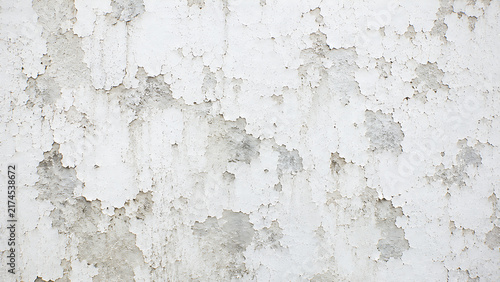 Weathered white wall texture with peeling paint. Distressed concrete surface background. Grungy aged plaster for architectural design.