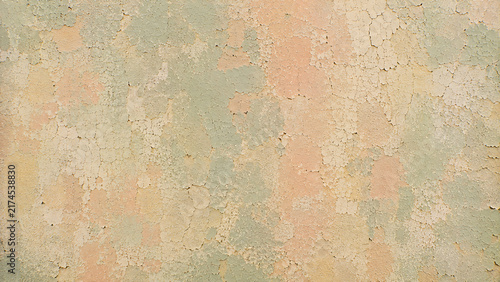 Vintage weathered wall texture, distressed pastel paint background, antique peeling plaster surface with peach and mint hues