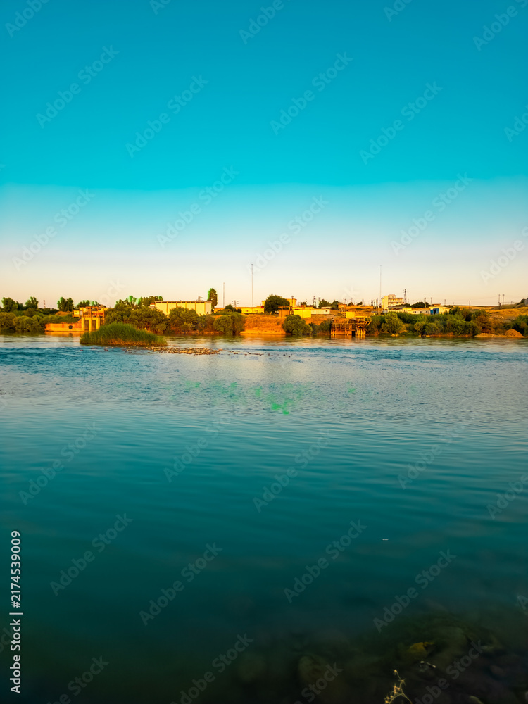 Naklejka premium River, houses and blue sky 