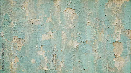 Weathered blue peeling paint texture, distressed turquoise wall surface, aged concrete background with cracked paint layers