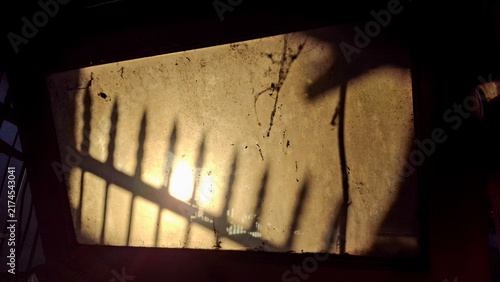 Bild auf Leinwand silhouette sun light through dirty window