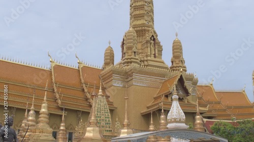 ornate golden stupas tiered rooflines and towering central prang at the great hall of vajradhamma in ancient city, thailand 
