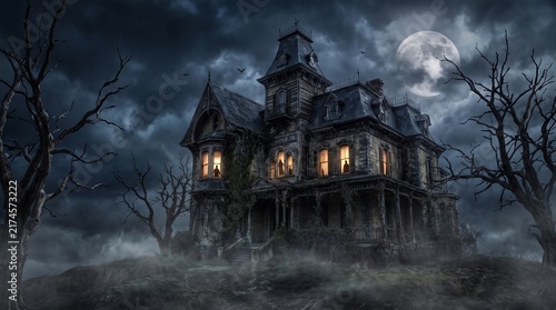 Spooky haunted Victorian mansion under full moon and dark stormy night sky