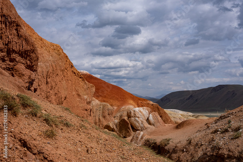 A beautiful mountain landscape with colorful clay mountains on a cloudy summer day