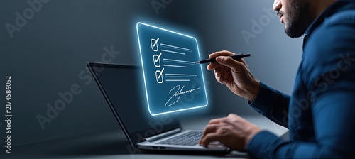Man signing digital document on laptop with stylus, electronic signature concept.