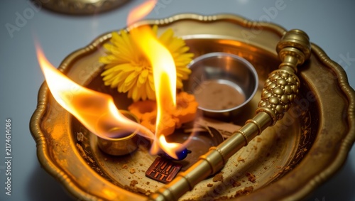 Golden brass ritual tray with vibrant camphor flames and fresh orange marigolds glowing warmly