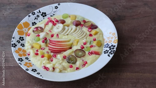 Delicious Mixed Fruit Custard Served in Plate - Fresh Banana, Apple, Grape, Pomegranate Dessert, Healthy Food Concept