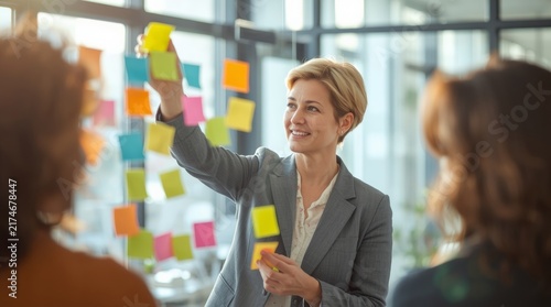 Professional woman leading collaborative brainstorming session with colorful sticky notes