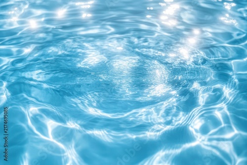 Sunlit turquoise pool water with shimmering ripples and gentle circular waves, calm and refreshing