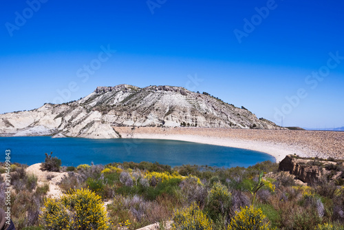 Canvastavla Panoramic view of a large water reservoir created by an earth dam, featuring a v