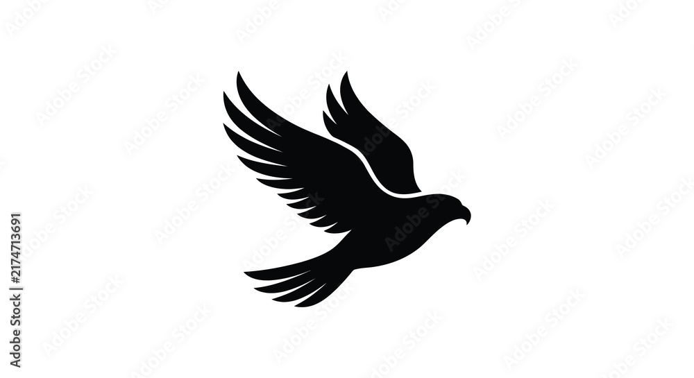 Fototapeta premium A black silhouette of a soaring eagle with outstretched wings against a white background