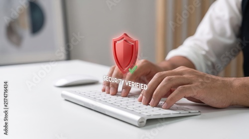 Cyber security verified featuring red shield icon with green checkmark hovering over computer keyboard, data protection and privacy assurance visualization, safe internet browsing