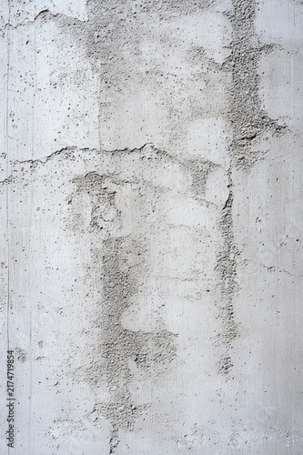 Close-up of weathered concrete wall with rough plaster patches, streaks and subtle cracks, muted neutral tones conveying an aged, austere minimalist mood