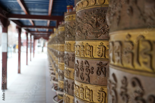 Fotografie Tibetan Buddhist Prayer Wheels in a Monastery Corridor