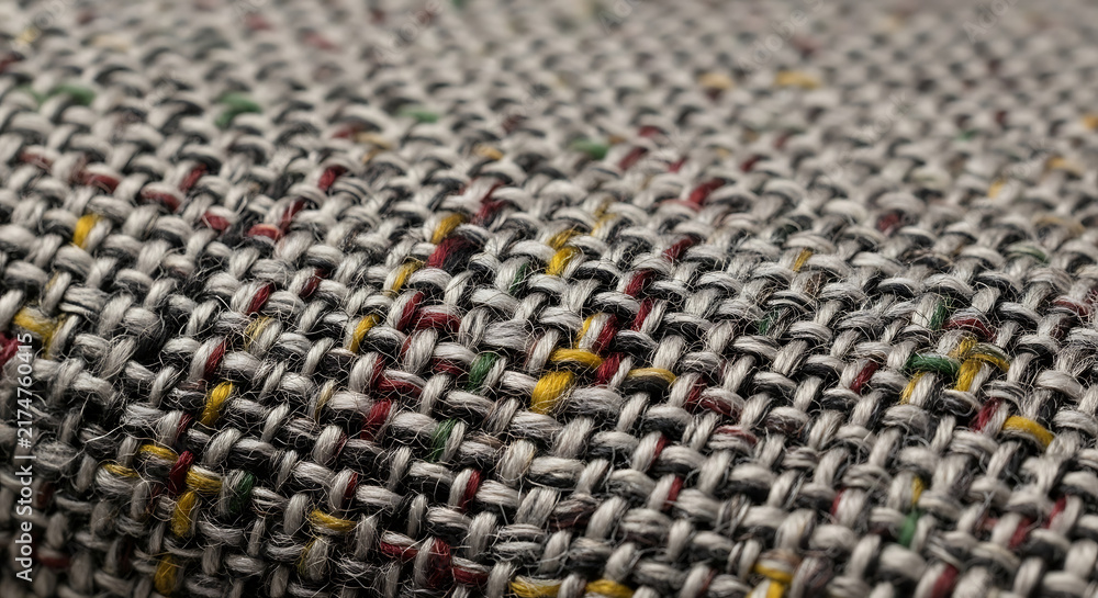Fototapeta premium Close-up of textured woven fabric surface - A detailed close-up image showcasing the intricate texture of a woven fabric, highlighting its natural pattern and tactile appeal.
