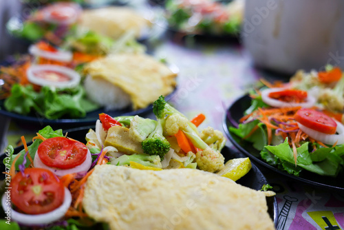 Vegetarian taco with salad and fresh vegetables on plate
