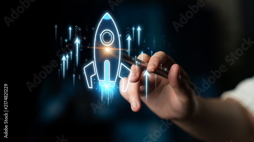 Obraz na płótnie Hand of a professional illustrating a digital rocket design, emphasizing growth,