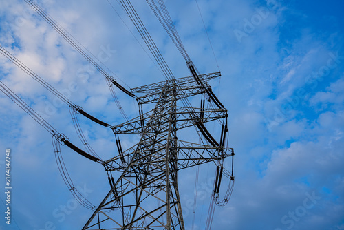Cuadro en lienzo High voltage transmission tower, power pylon against cloudy blue sky