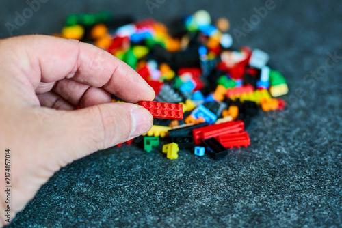 Hand Holding Bricks - Creative Play Concept