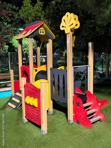 Quadro su tela Colorful children playground equipment with slides and climbing frames