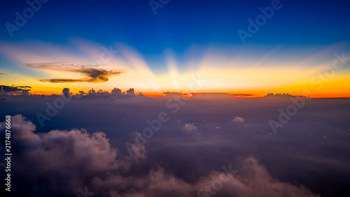 Bild auf Leinwand Stunning mountain landscape with crepuscular rays at sunrise above sea of clouds