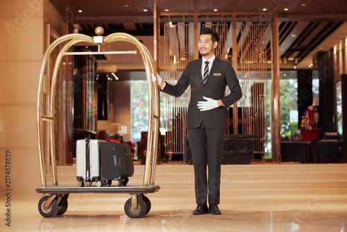 Canvastavla Hotel concierge with luggage cart in luxury hotel lobby