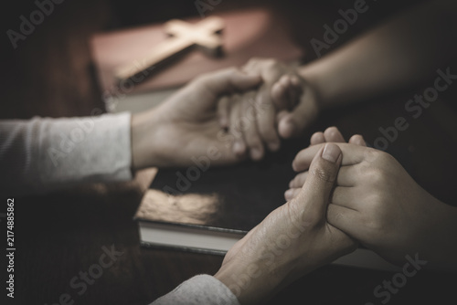 Konstfotografi Two people praying together and holding hands, expressing faith, love, trust, hope, and spiritual support