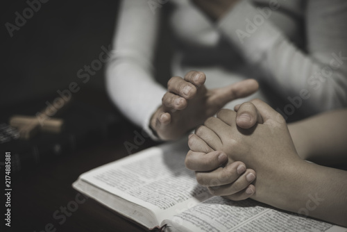 Fotografie Two people in a shared prayer, holding hands with faith in God and offering support, comfort, peace, and blessing