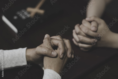 Fotografie Two people holding hands and praying for each other, showing love, care, faith, hope, and spiritual connection