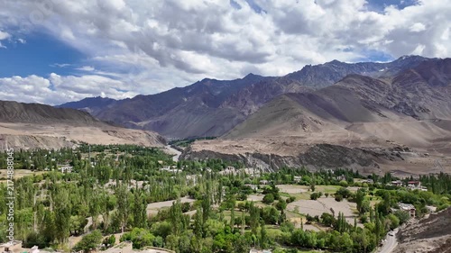 Saspol, India : Panoramic footage of green area surrounded by arid mountains in Saspol, a village famous for ancient buddhist cave in Sham district of Ladakh valley along Indus river on sunny day