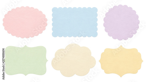 Six pastel scalloped paper label shapes in soft pink, blue, purple, green, cream and yellow arranged on a transparent background