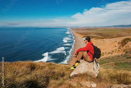 Travel in Point Reyes National Seashore, man Hiker with backpack enjoying view, California, USA