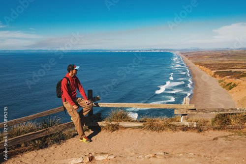 Travel in Point Reyes National Seashore, man Hiker with backpack enjoying view, California, USA
