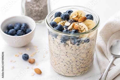 Overnight oats with blueberries banana and almonds in glass jar