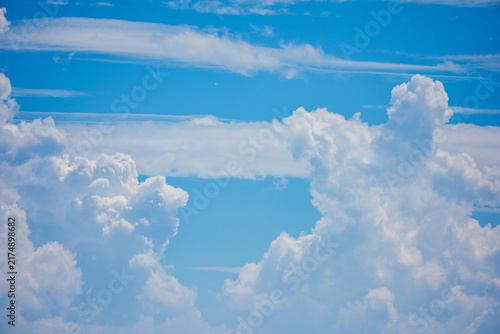 Billowing clouds and blue sky on sunny day
