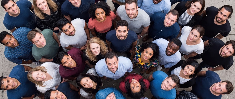 Obraz premium Diverse group of happy multiethnic people looking up high angle view