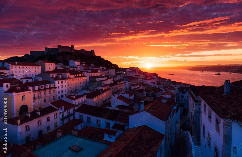 Obraz premium Sunset coastal cityscape of sao jorge with fortress hilltop, white facades, red tiled rooftops, glowing sea reflections and vibrant Mediterranean architectural scenery generate ai