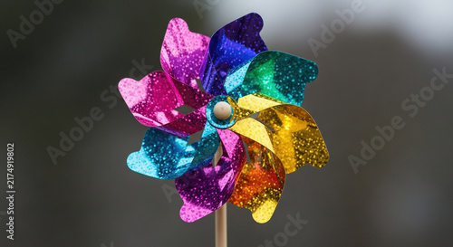 Colorful metallic pinwheel against dark background