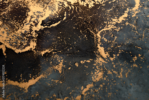 Artistic background featuring blue-gray swirls with gold accents; wide shot.