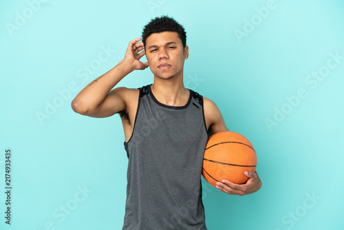 Canvastavla Basketball player African American man isolated on blue background having doubts
