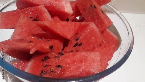 Watermelon pieces with black seeds in glass bowl video footage. Watermelon healthy nutritional sweet tropical fruit in summer season. 