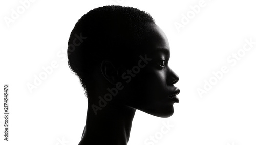 Isolated dramatic black and white profile portrait of beautiful young African woman with curly hair