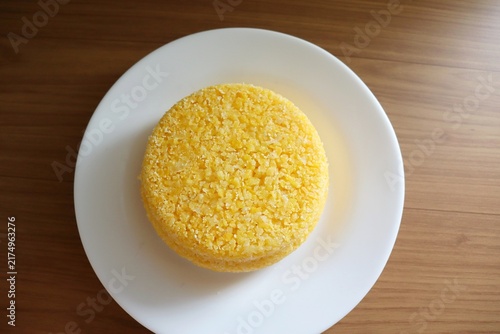 Brazilian couscous on a wooden background. Couscous (Cuscuz, in Portuguese) is a typical northeastern Brazil breakfast.