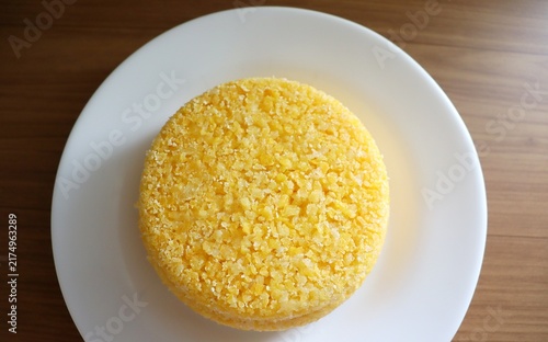 Brazilian couscous on a wooden background. Couscous (Cuscuz, in Portuguese) is a typical northeastern Brazil breakfast.
