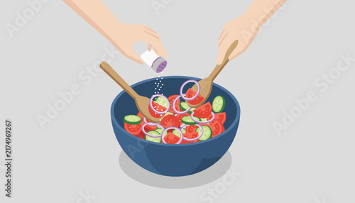 Home cook seasons fresh vegetable salad with a salt shaker while tossing sliced tomatoes, cucumbers, and red onion.