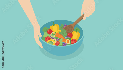 Healthy fresh vegetable salad filled with carrots, peppers, and tomatoes is tossed with wooden spoon in blue bowl.