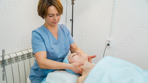 Face massage. Professional doing face massage to a customer