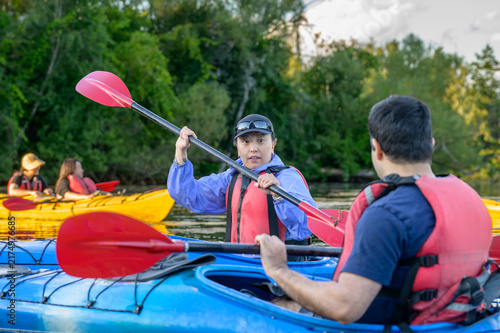 Canvas Print Kayaker practicing paddle strokes during an evening group paddle on the Toronto