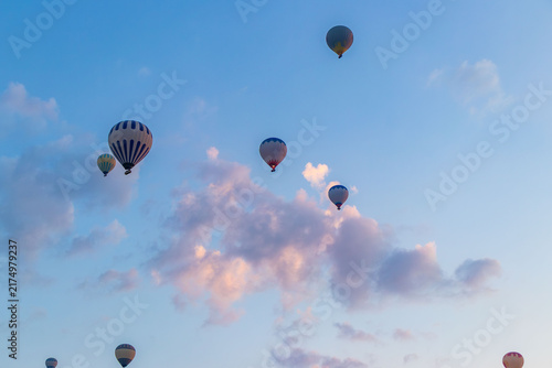Hot air balloons flying over rocky valley at sunset. Hot air ballooning represents freedom exploration dream.