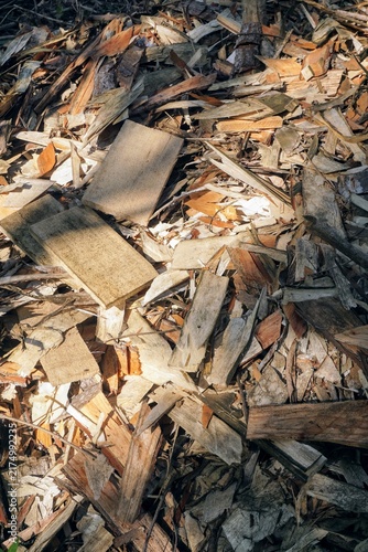 Top view of a pile of wood chips and leftover board cutoffs in a timber processing industry.